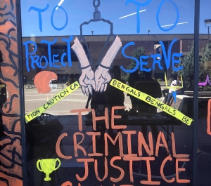 Window painting with name "Criminal Justice Club" printed 
